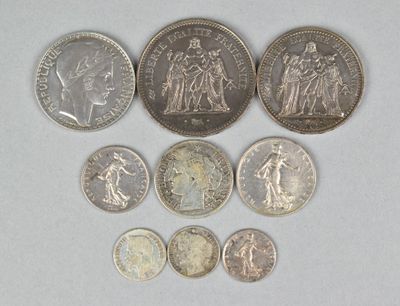 several different coins are arranged in a row on a white surface