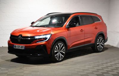 the orange car is parked in the garage of the building