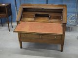 un petit bureau muni d'un tiroir, dans une pièce