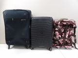 two pieces of luggage sitting next to each other on the floor
