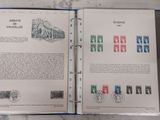 an open book with stamps on it sitting on a table