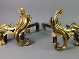 two gold colored sculptures on a gray surface