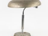 an old desk lamp with a metal base on a white background