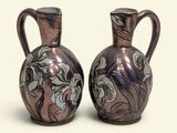 two vases sitting side by side on a white surface