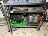 a metal cart with a bunch of pans on top of it