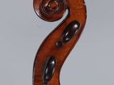 an antique violin with a scroll on the back of it