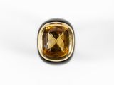 a close up of a ring with a large brown stone in it