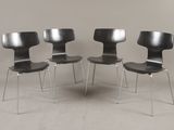 three black chairs sitting next to each other on a white floor