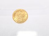 an image of a gold coin in a clear box