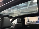 a view of a car ' s sunroof from inside the car