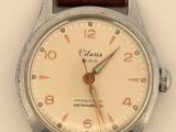 a close up of a wrist watch with a brown leather strap