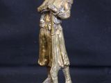 bronze statue of a man holding a bag on a black background