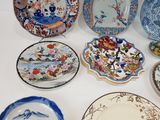 many plates that are sitting on the table together