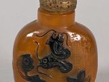 a small glass bottle with a design on it