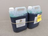 two gallons of blue liquid sitting next to each other on a table