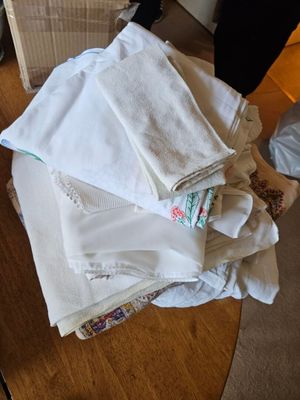 a pile of folded towels sitting on top of a wooden table