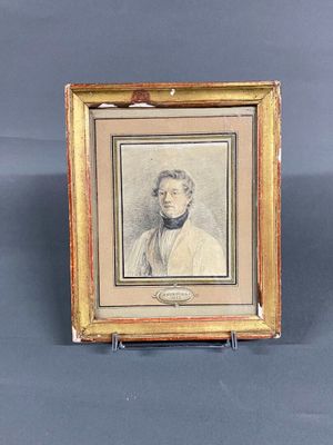 an old picture of a man in a suit and tie in a gold frame