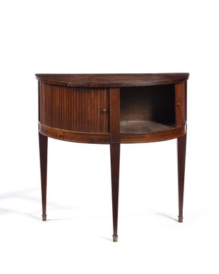an oval walnut side table with a shelf on one side and a drawer on the other