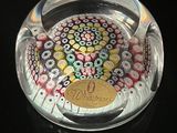 a glass ashtray with a colorful design on it