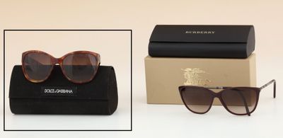 two pairs of sunglasses are sitting on a table next to a box