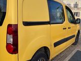 the yellow van is parked on the side of the street