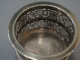 a silver cup that is sitting on a table
