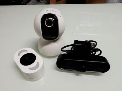 a white camera and a remote control on a table