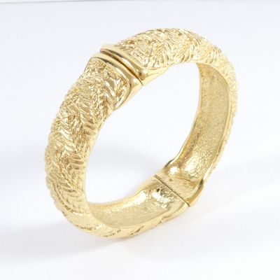 a close up of a gold ring on a white surface