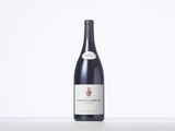 a bottle of red wine sitting on top of a table