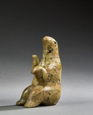 an image of a statue of a bear sitting on its back