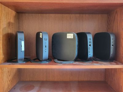 a lot of speakers on a shelf in a room