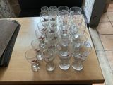 a lot of glasses sitting on a table on the floor