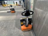 a forklift that is sitting in the middle of a warehouse