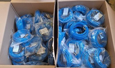 two boxes of blue cables are stacked on top of each other