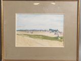 tableau encadré représentant une scène de plage avec des personnes marchant sur le sable