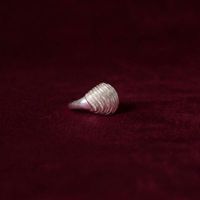 a close up of a silver ring on a red cloth