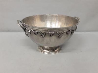 a silver bowl with handles and handles on a white surface