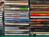 a lot of cds that are stacked on top of each other