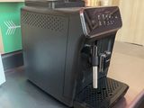 a black coffee machine sitting on a counter in a kitchen
