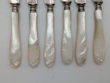 four silverware pieces with mother of pearl handles and a knife