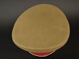 an image of a brown hat with a red band on a black surface