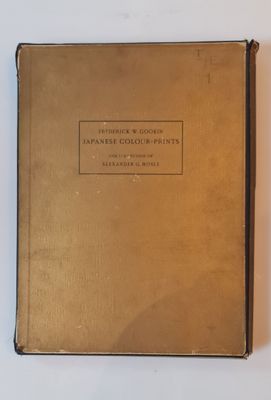 an old book sitting on top of a table next to a white table