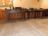 a room with a table, chairs, and other items on the floor