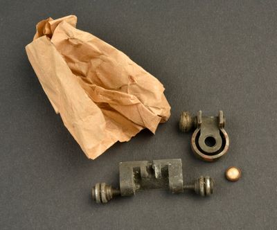 a brown paper bag and some metal fittings on a table