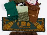 many different types of scarves laid out on a table