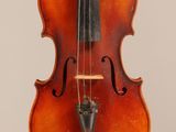 an old violin with a bow hanging from it ' s back
