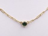 a gold chain necklace with a green stone on it