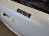a close up of a car door handle with a sticker on it