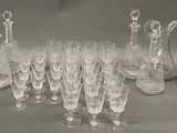 a lot of wine glasses and a pitcher on the table