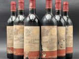 six bottles of red wine are lined up in a row